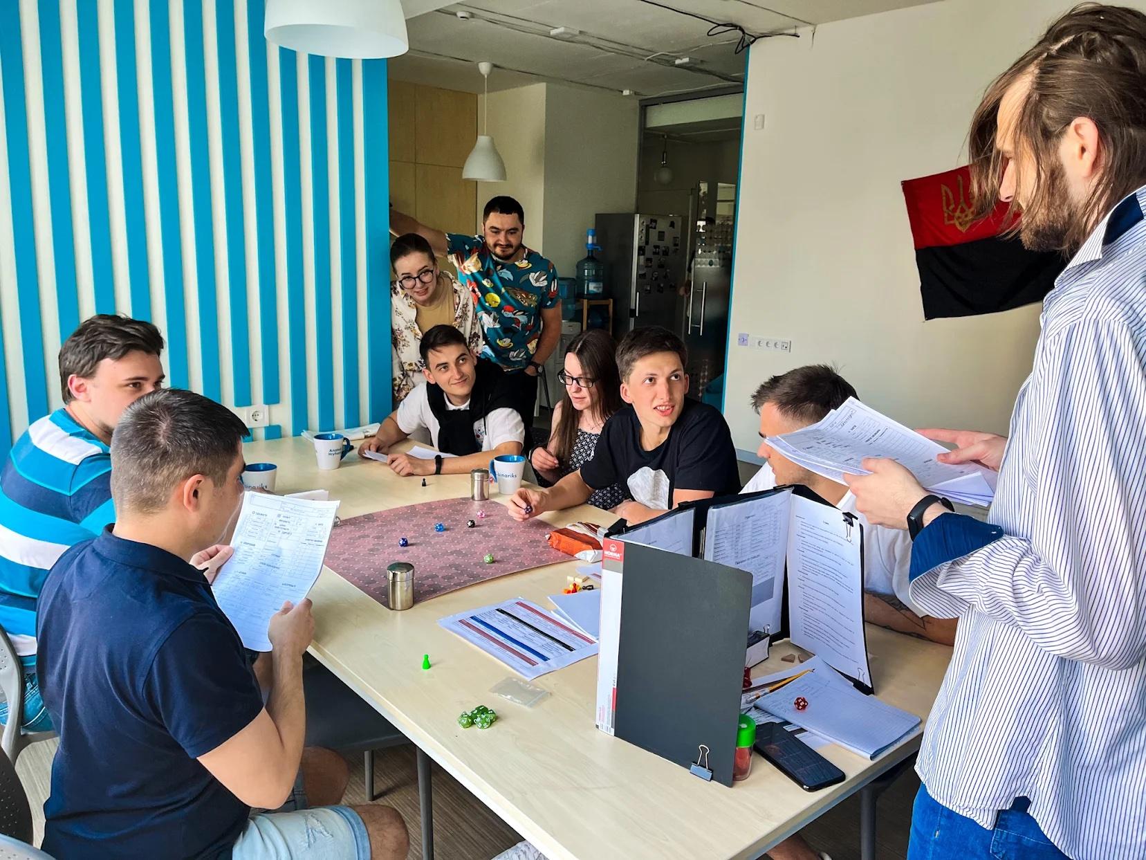 Binariks colleagues playing a tabletop game in the office