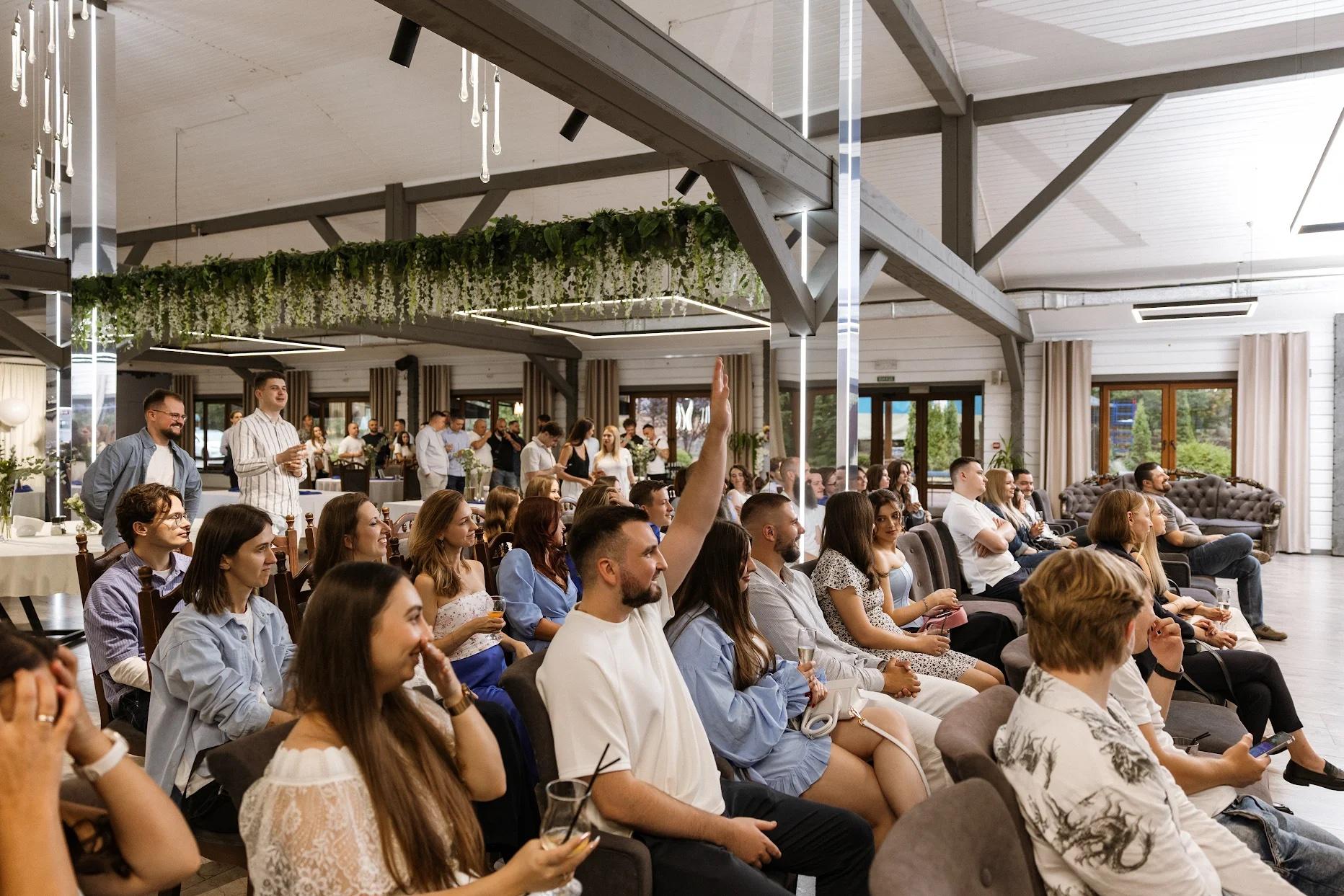 Binariks colleagues raising a hand to bid at the company charity auction